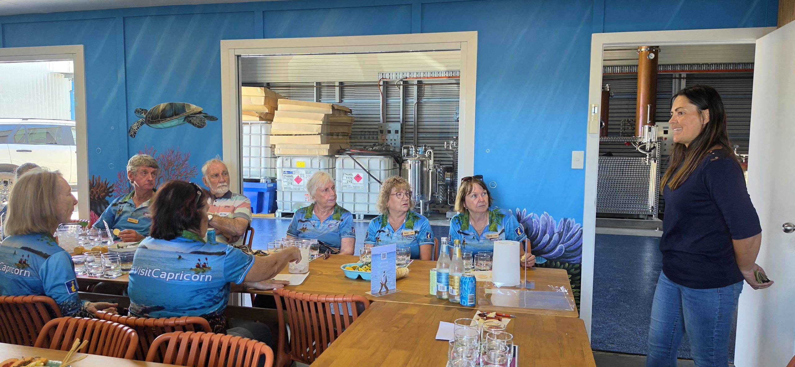 Visitor information centre volunteers raise a glass a Reef Distillers